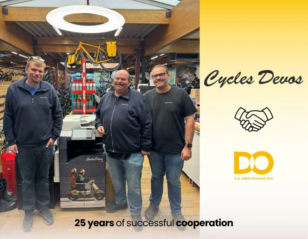 Image celebrating 25 years of partnership between Cycles Devos and D&O Partners, featuring representatives from both companies in a symbolic event.