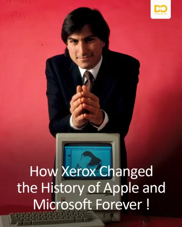 Steve Jobs en costume derrière un Macintosh sur fond rouge
